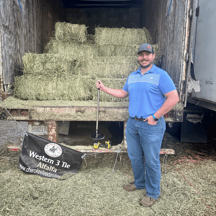 Our rep., Geff, who is standing next to a truck of hay.